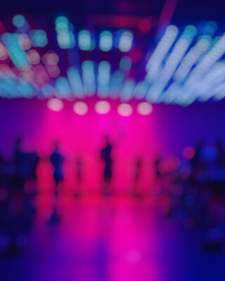 blurred picture of a class taking place in a studio with cool lighting effect